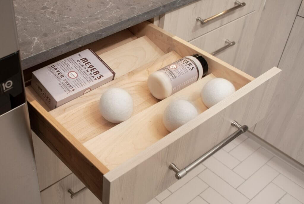 tiered spice storage drawer used in laundry room as an alternative use for kitchen cabinets